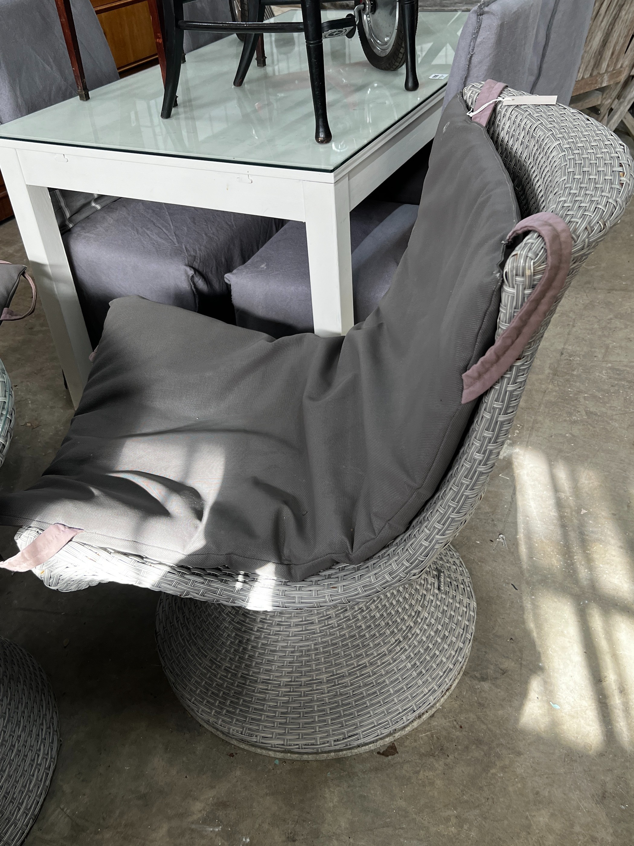 A 'Canadian Furniture' all weather rattan circular garden table, diameter 80cm, height 67cm and four chairs with cushions *Please note the sale commences at 9am.